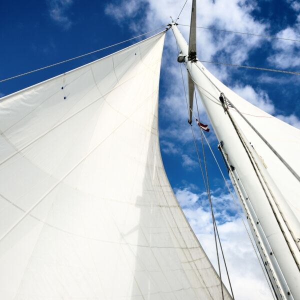 View upwards to the mast of a sailboat on a summer day